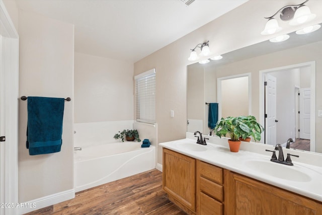 23705 N Chaps Dr, Florence, AZ 85132 - full bath with wood finished floors, double vanity, a bath, and baseboards
