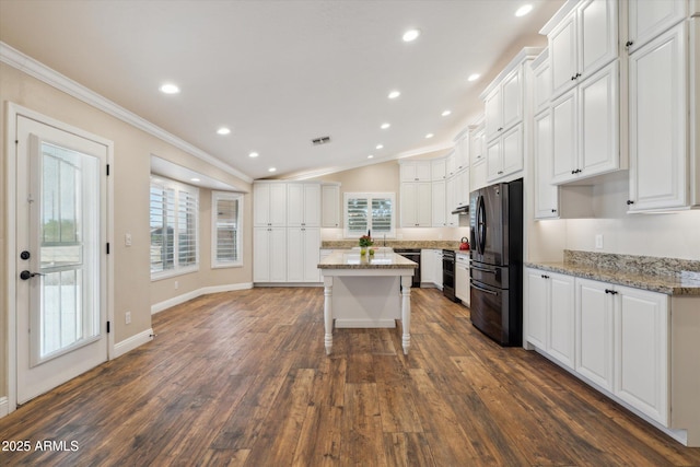 23705 N Chaps Dr, Florence, AZ 85132 - kitchen with freestanding refrigerator, ornamental molding, white cabinetry, dark wood finished floors, and recessed lighting