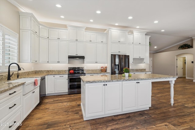23705 N Chaps Dr, Florence, AZ 85132 - kitchen featuring stainless steel appliances, a kitchen island, a sink, ornamental molding, and arched walkways