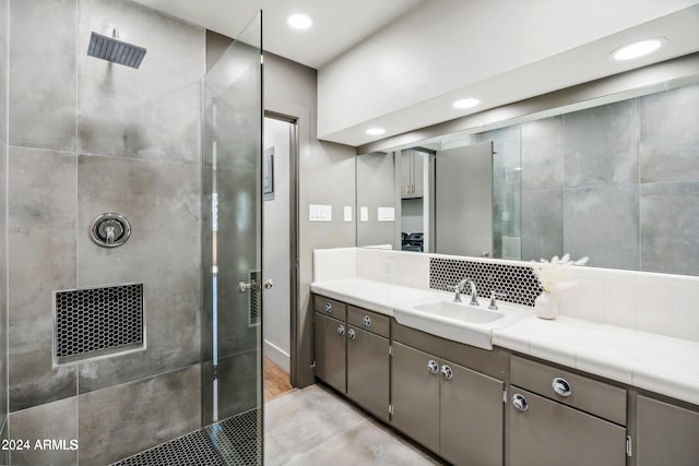 103 E Palm Ln Unit A, Phoenix, AZ 85004 - bathroom featuring a walk in shower, vanity, tasteful backsplash, and recessed lighting