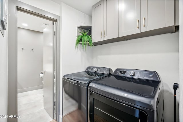 103 E Palm Ln Unit A, Phoenix, AZ 85004 - clothes washing area featuring separate washer and dryer and cabinet space