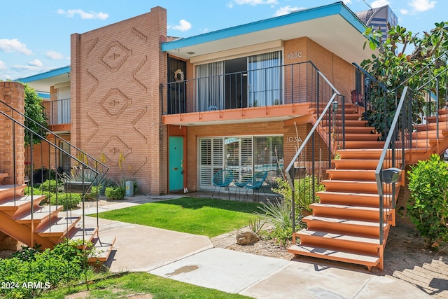 103 E Palm Ln Unit A, Phoenix, AZ 85004 - rear view of property with stairs and brick siding