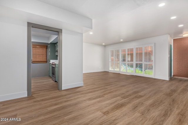 103 E Palm Ln Unit A, Phoenix, AZ 85004 - unfurnished living room with recessed lighting, light wood finished floors, and baseboards