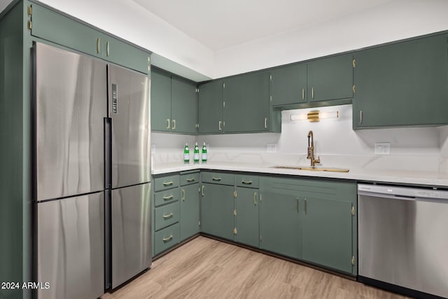 103 E Palm Ln Unit A, Phoenix, AZ 85004 - kitchen with stainless steel appliances, a sink, light wood finished floors, and light countertops