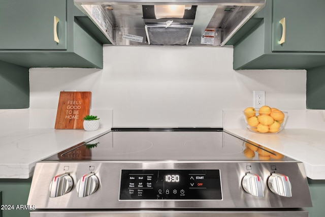 103 E Palm Ln Unit A, Phoenix, AZ 85004 - kitchen featuring green cabinets, stainless steel electric stove, and ventilation hood