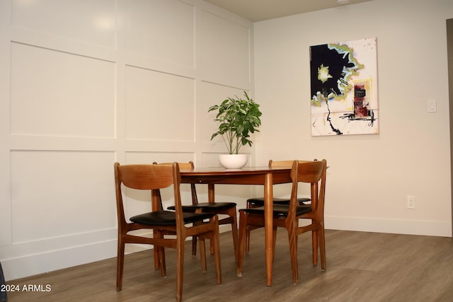 103 E Palm Ln Unit A, Phoenix, AZ 85004 - dining area featuring wood finished floors and baseboards