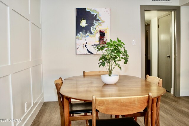 103 E Palm Ln Unit A, Phoenix, AZ 85004 - dining space featuring light wood-style flooring and baseboards