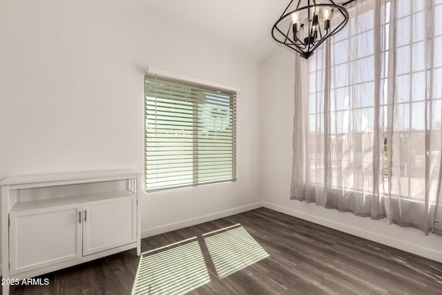 830 E Gila Ln, Chandler, AZ 85225 - unfurnished dining area with a chandelier, dark wood-style flooring, and baseboards