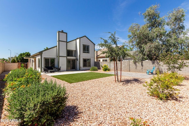 830 E Gila Ln, Chandler, AZ 85225 - rear view of property featuring a fenced backyard, a patio, and a chimney