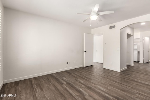 830 E Gila Ln, Chandler, AZ 85225 - empty room with arched walkways, dark wood-style flooring, a ceiling fan, and baseboards