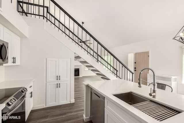 830 E Gila Ln, Chandler, AZ 85225 - kitchen with a sink, appliances with stainless steel finishes, a towering ceiling, dark wood finished floors, and white cabinetry