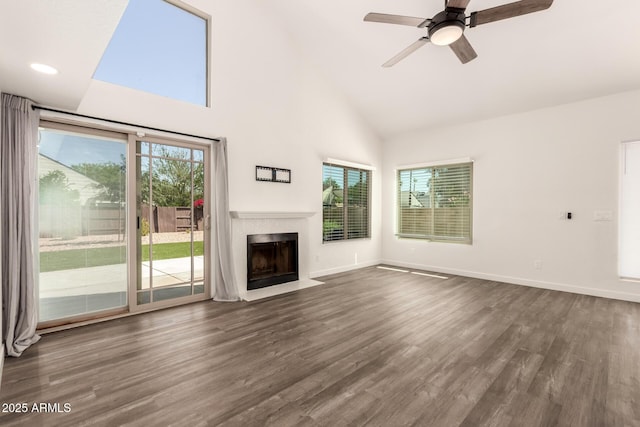 830 E Gila Ln, Chandler, AZ 85225 - unfurnished living room with high vaulted ceiling, dark wood finished floors, a fireplace with flush hearth, a ceiling fan, and baseboards