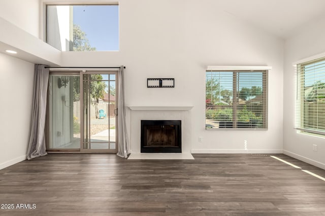 830 E Gila Ln, Chandler, AZ 85225 - unfurnished living room featuring high vaulted ceiling, plenty of natural light, a fireplace with flush hearth, wood finished floors, and baseboards