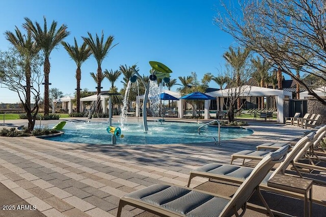 view of swimming pool with pool water feature