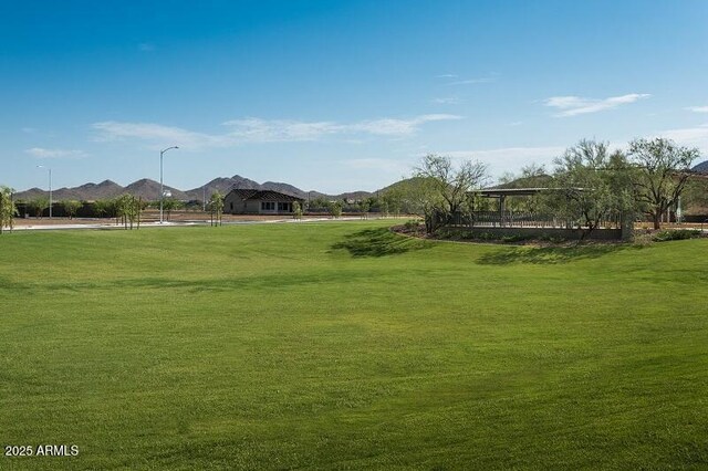 view of home's community featuring a lawn and a mountain view