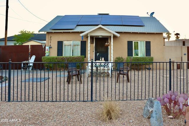 2014 N 17th Pl, Phoenix, AZ 85006 - bungalow-style house with stucco siding, solar panels, and a patio area