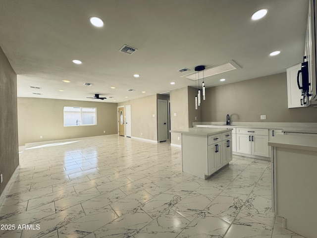 kitchen with recessed lighting, marble finish floor, visible vents, and open floor plan