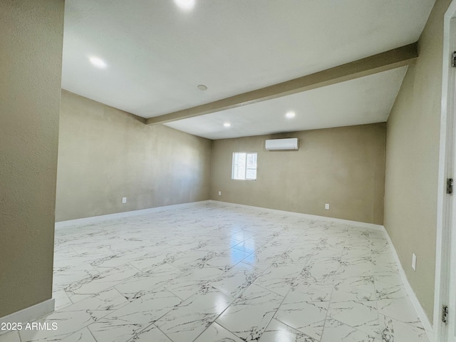 spare room with marble finish floor, beam ceiling, and baseboards