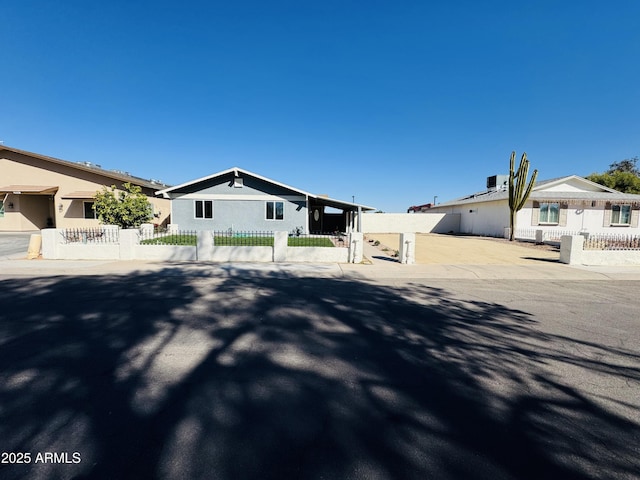 view of front of home with a fenced front yard and stucco siding