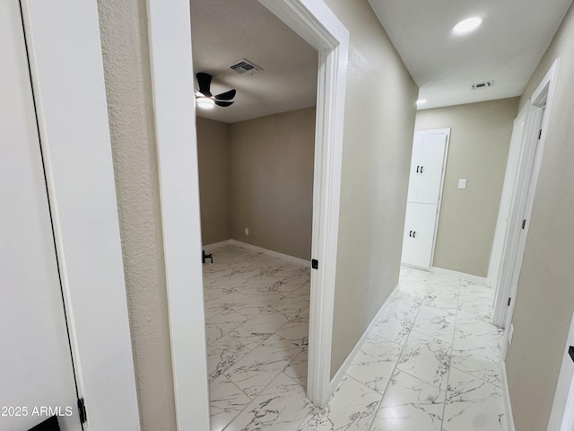 hallway featuring recessed lighting, marble finish floor, visible vents, and baseboards