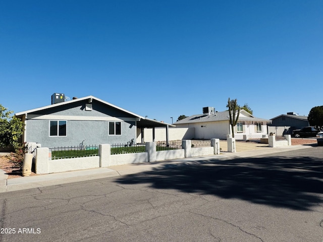 view of front of house featuring a fenced front yard and stucco siding