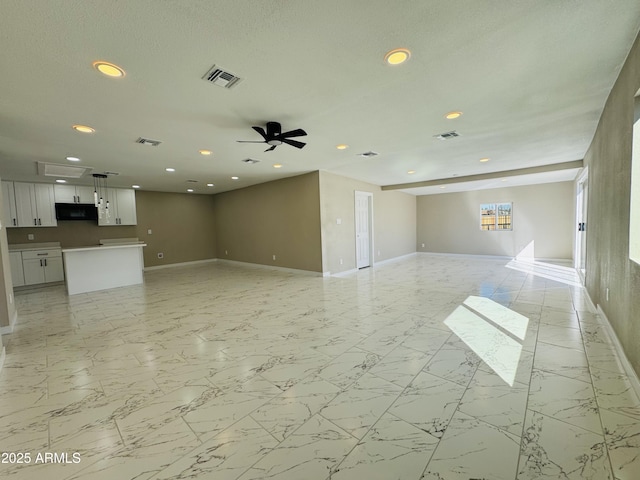 unfurnished living room with marble finish floor, visible vents, and baseboards