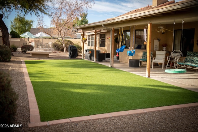 view of yard with a patio, a fenced backyard, and a ceiling fan