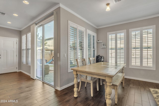 dining space featuring ornamental molding and dark hardwood / wood-style flooring