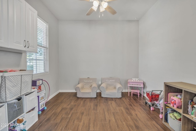 playroom featuring dark wood-type flooring and ceiling fan