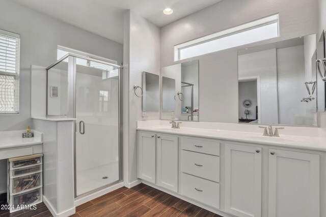 bathroom featuring walk in shower, vanity, and hardwood / wood-style floors