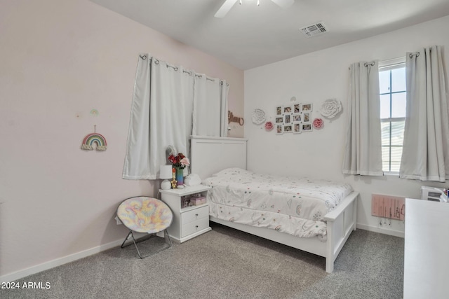 bedroom with radiator heating unit, ceiling fan, and carpet flooring