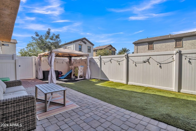 view of patio featuring a playground, a gazebo, and an outdoor living space