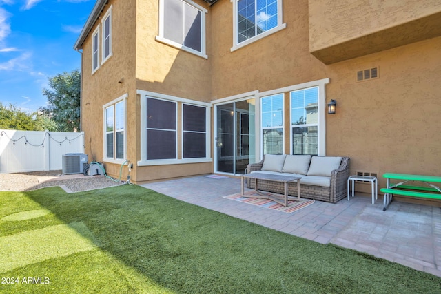 rear view of property featuring an outdoor hangout area, a yard, a patio area, and central AC