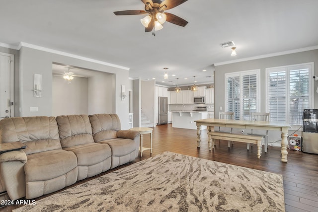 living room with ceiling fan, ornamental molding, and hardwood / wood-style flooring