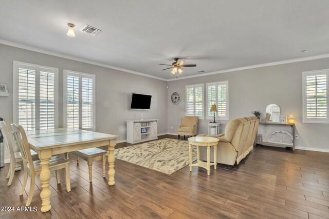 living room featuring ornamental molding, dark wood-type flooring, and ceiling fan