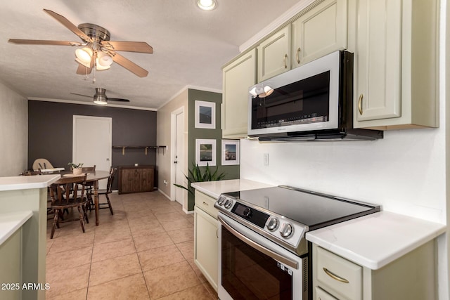 5031 W Grandview Rd, Glendale, AZ 85306 - kitchen featuring stainless steel electric range, light countertops, ceiling fan, light tile patterned floors, and crown molding