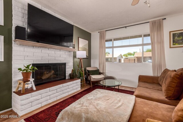 5031 W Grandview Rd, Glendale, AZ 85306 - living area featuring a brick fireplace, wood finished floors, crown molding, and ceiling fan