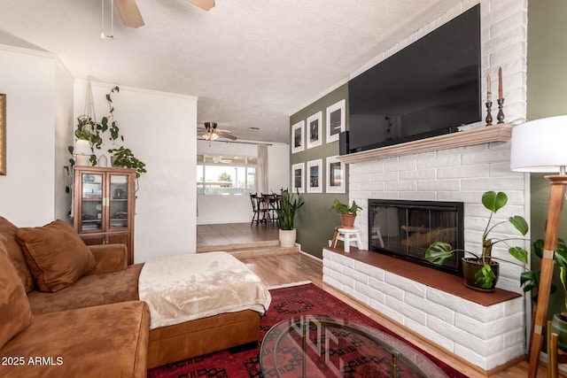 5031 W Grandview Rd, Glendale, AZ 85306 - living area featuring a ceiling fan, wood finished floors, a brick fireplace, and a textured ceiling