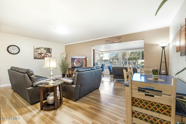 living room featuring light wood-type flooring and baseboards