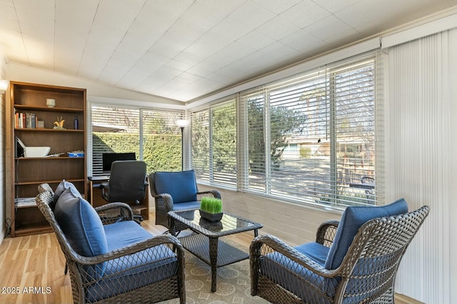 sitting room featuring a wealth of natural light, vaulted ceiling, and wood finished floors