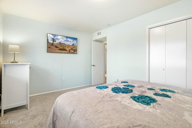 bedroom featuring carpet floors, a closet, visible vents, and baseboards