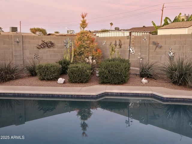 view of pool at dusk