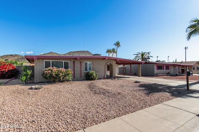 single story home featuring a carport