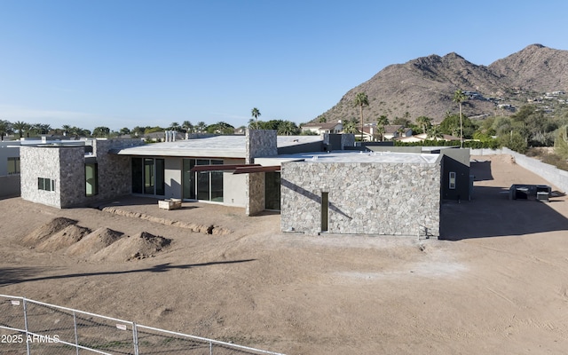 exterior space featuring fence and a mountain view