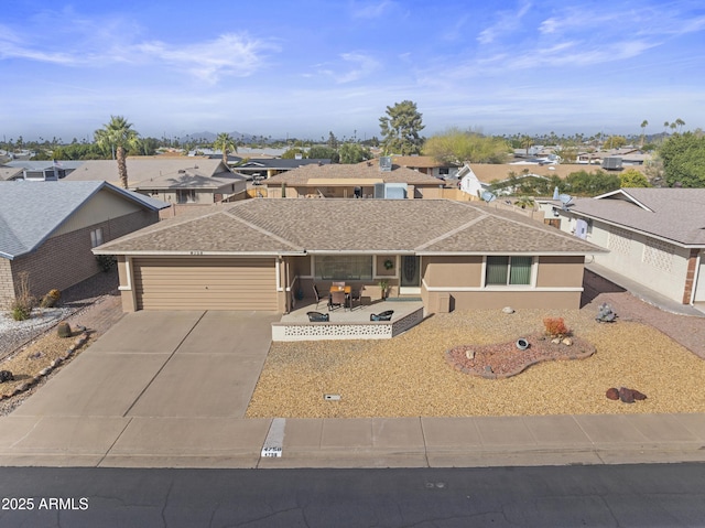 view of front facade featuring a garage and a patio area