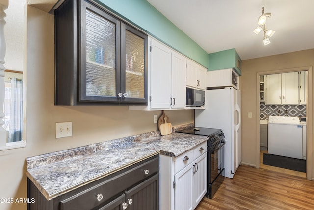 kitchen with decorative backsplash, wood-type flooring, white cabinets, and black appliances