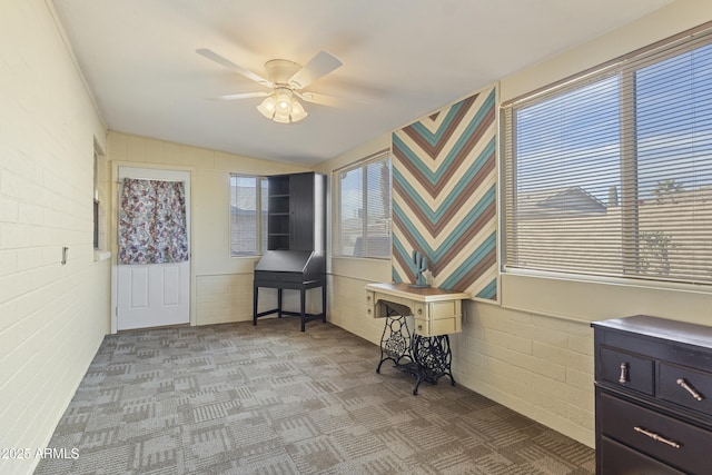 sitting room featuring ceiling fan, light colored carpet, and lofted ceiling