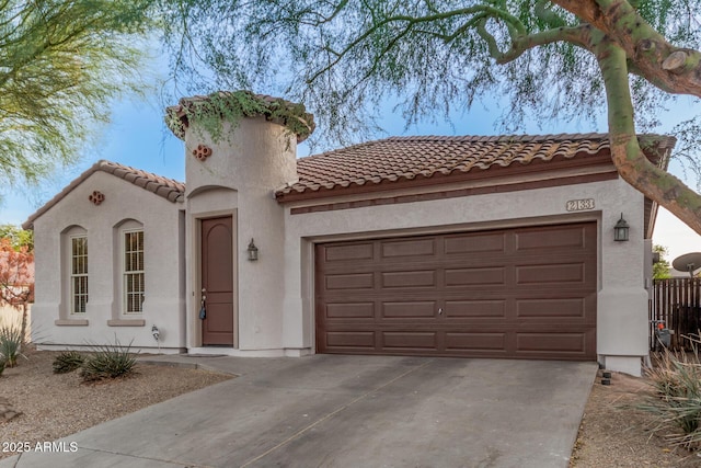 mediterranean / spanish home featuring a garage, driveway, a tiled roof, and stucco siding