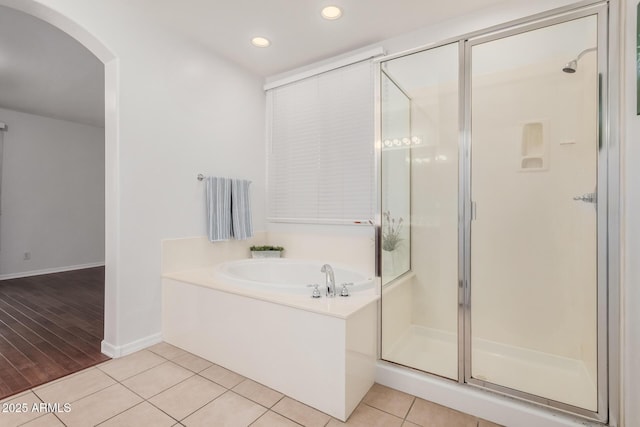 bathroom with tile patterned flooring and independent shower and bath