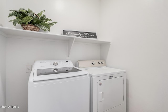 clothes washing area with washer and dryer and laundry area